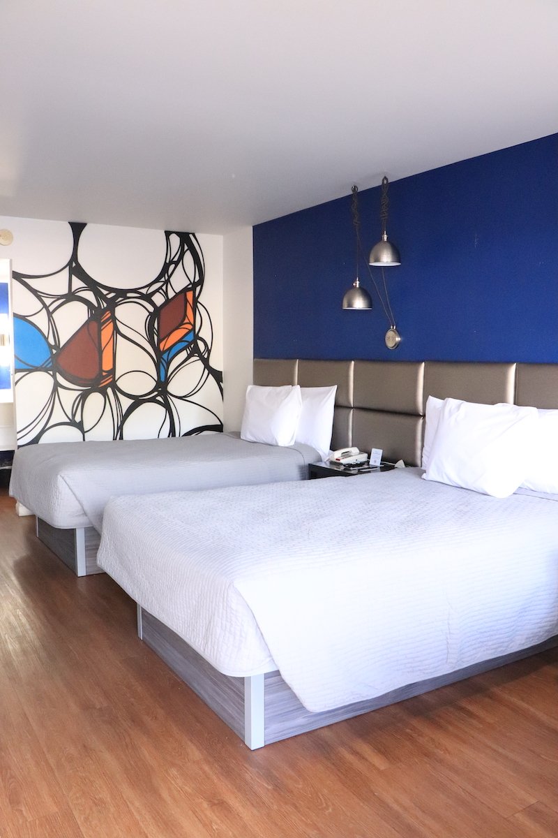 2 Double Beds — blue accent wall wide view