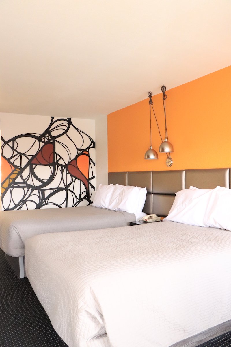 2 Double Beds — orange accent wall close view